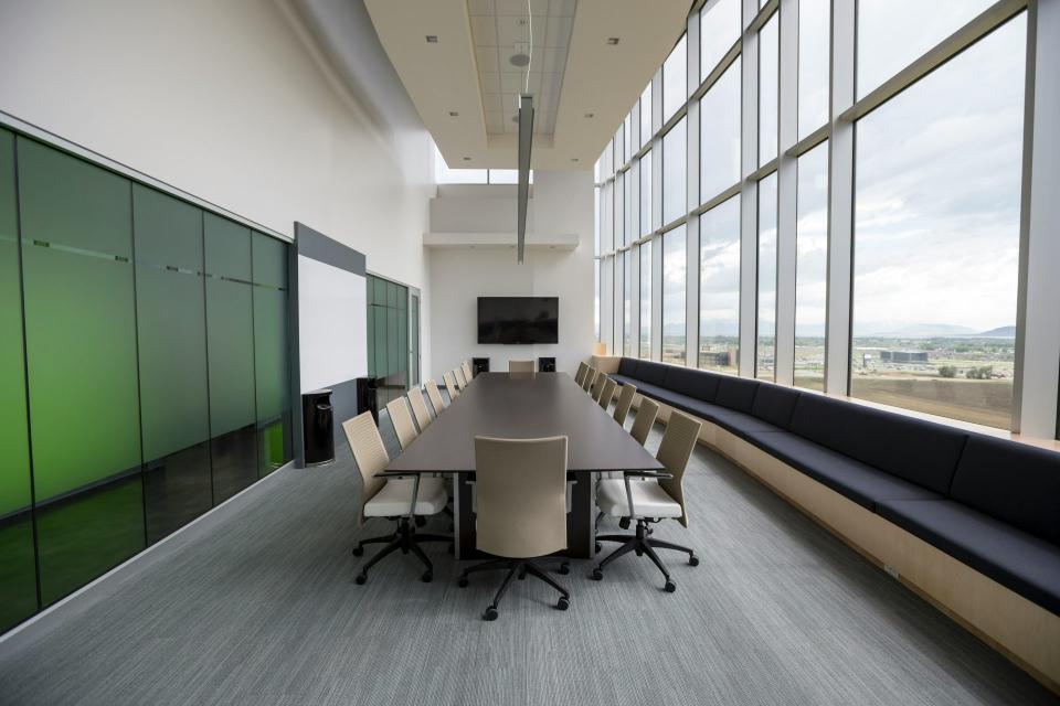 Spacious, modern conference room with large windows and seating.