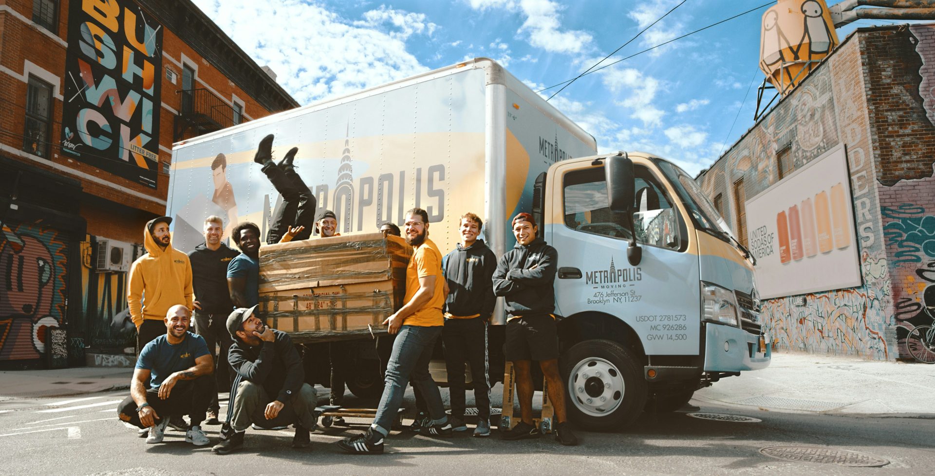 Group posing next to truck in urban setting